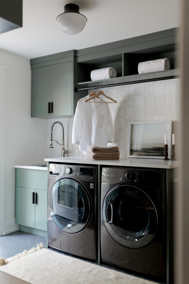 Inspiration for a mid-sized transitional single-wall dedicated laundry room in Toronto with an utility sink, quartz benchtops, an integrated washer and dryer and white benchtop.
