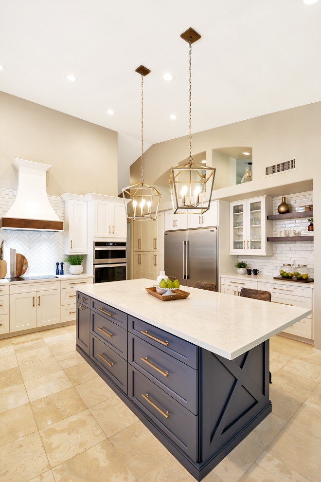 Open concept kitchen - large transitional u-shaped open concept kitchen idea in Phoenix with a farmhouse sink, shaker cabinets, white cabinets, quartz countertops, white backsplash, subway tile backsplash, stainless steel appliances, an island and white countertops
