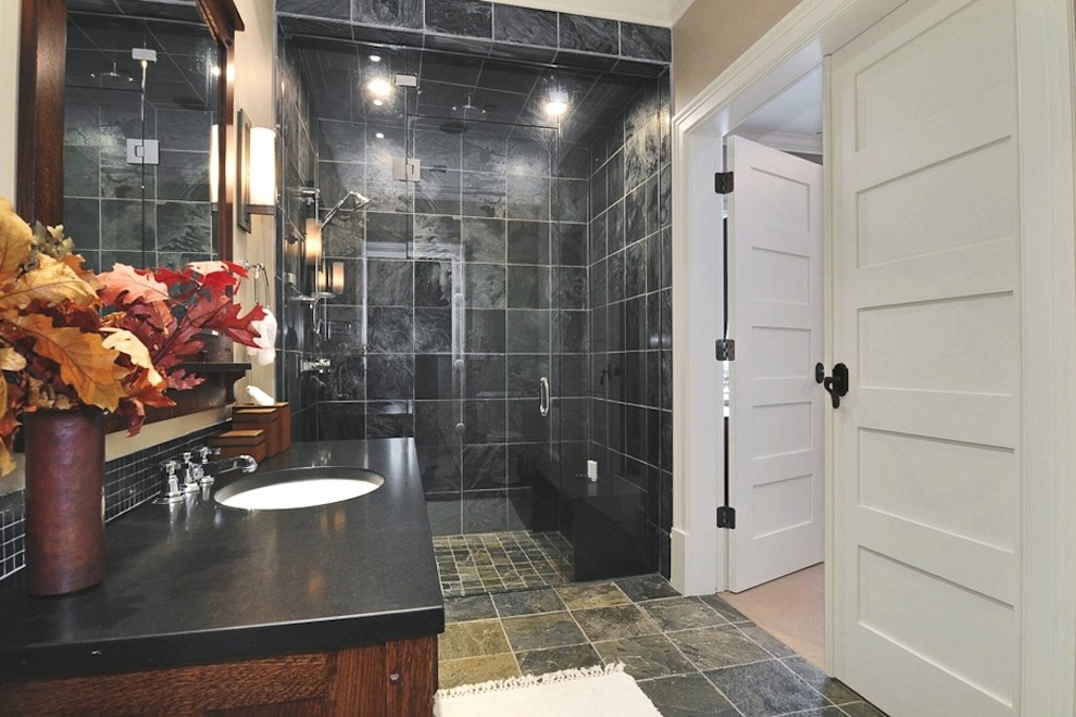 Photo of a traditional master bathroom in Vancouver with a console sink, medium wood cabinets, onyx benchtops, an alcove shower, a one-piece toilet, multi-coloured tile, stone tile, beige walls and ceramic floors.