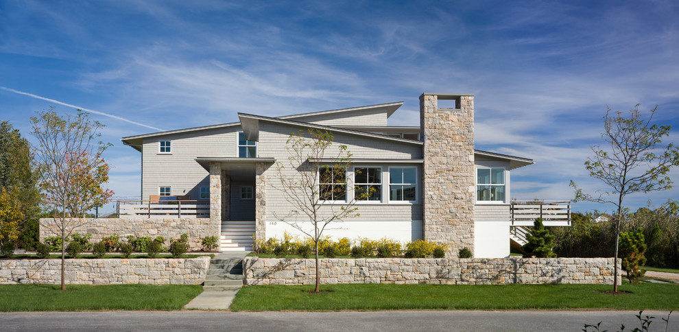 This is an example of a contemporary one-storey beige exterior in Providence with a shed roof.