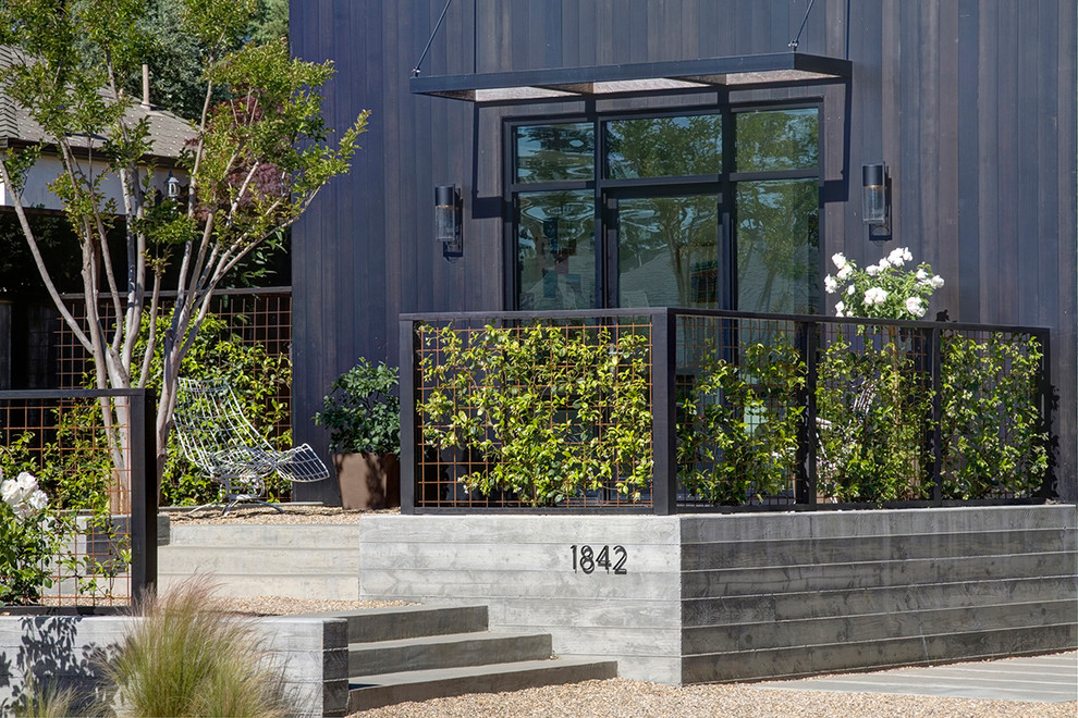 Large country two-storey black exterior in San Francisco with mixed siding.