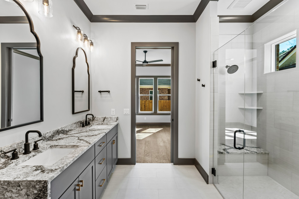 Inspiration for a mid-sized transitional master double-sink and white floor corner shower remodel with recessed-panel cabinets, gray cabinets, quartz countertops, a built-in vanity, an undermount sink, a hinged shower door and gray countertops