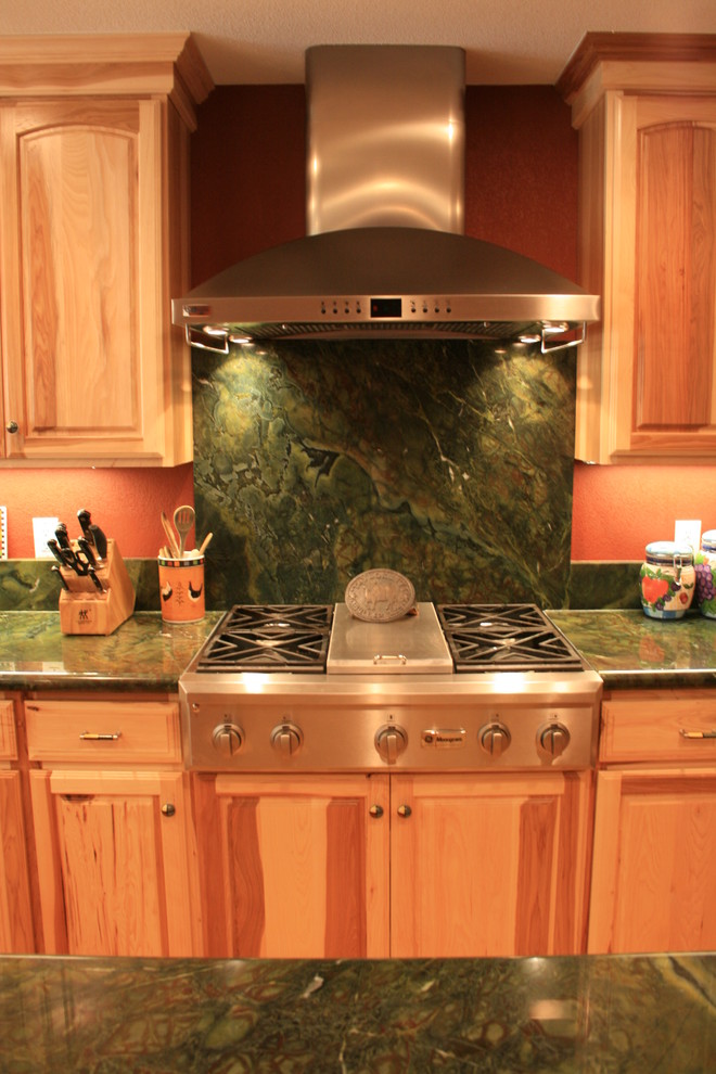 Inspiration for a mid-sized rustic u-shaped eat-in kitchen remodel in Sacramento with an undermount sink, raised-panel cabinets, light wood cabinets, granite countertops, green backsplash, stone slab backsplash, stainless steel appliances and an island