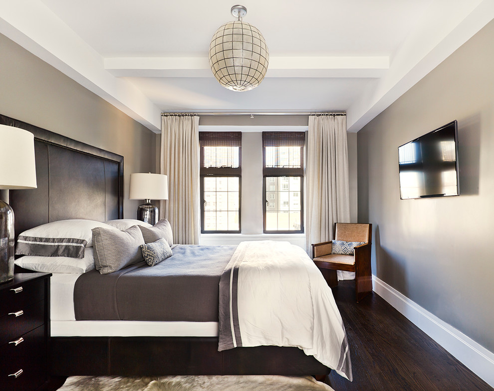 This is an example of a contemporary bedroom in New York with grey walls, dark hardwood floors and brown floor.