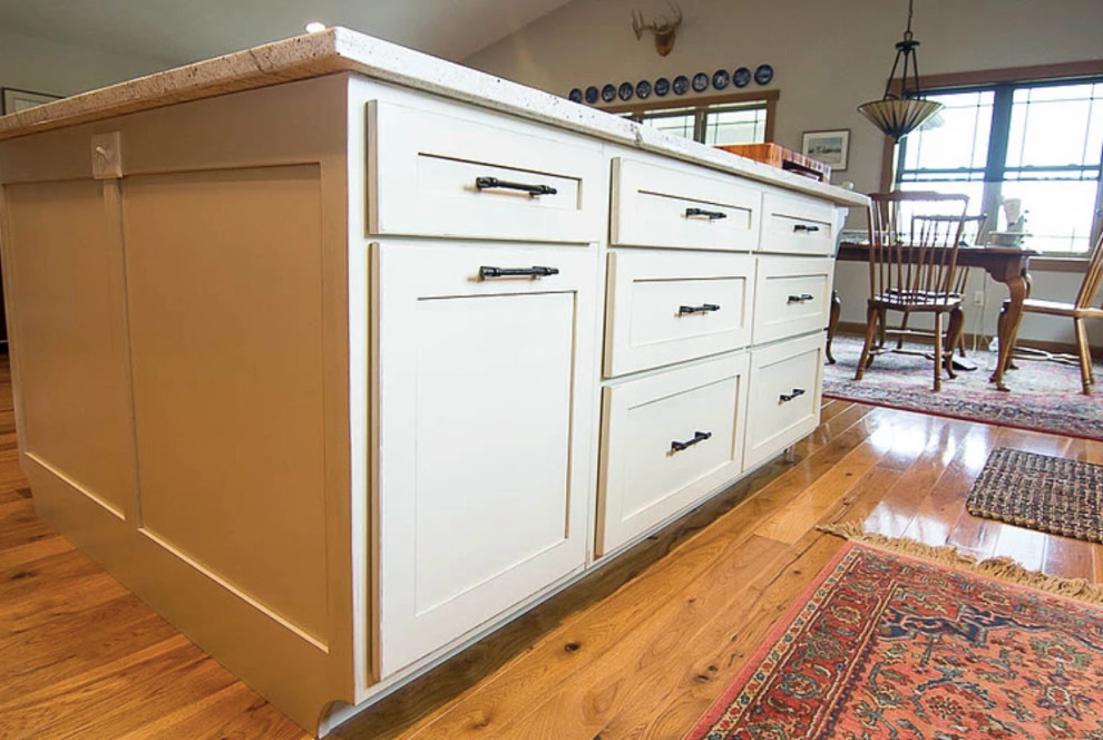 Open concept kitchen - mid-sized transitional l-shaped medium tone wood floor and brown floor open concept kitchen idea with a farmhouse sink, shaker cabinets, medium tone wood cabinets, quartzite countertops, gray backsplash, subway tile backsplash, stainless steel appliances, an island and white countertops
