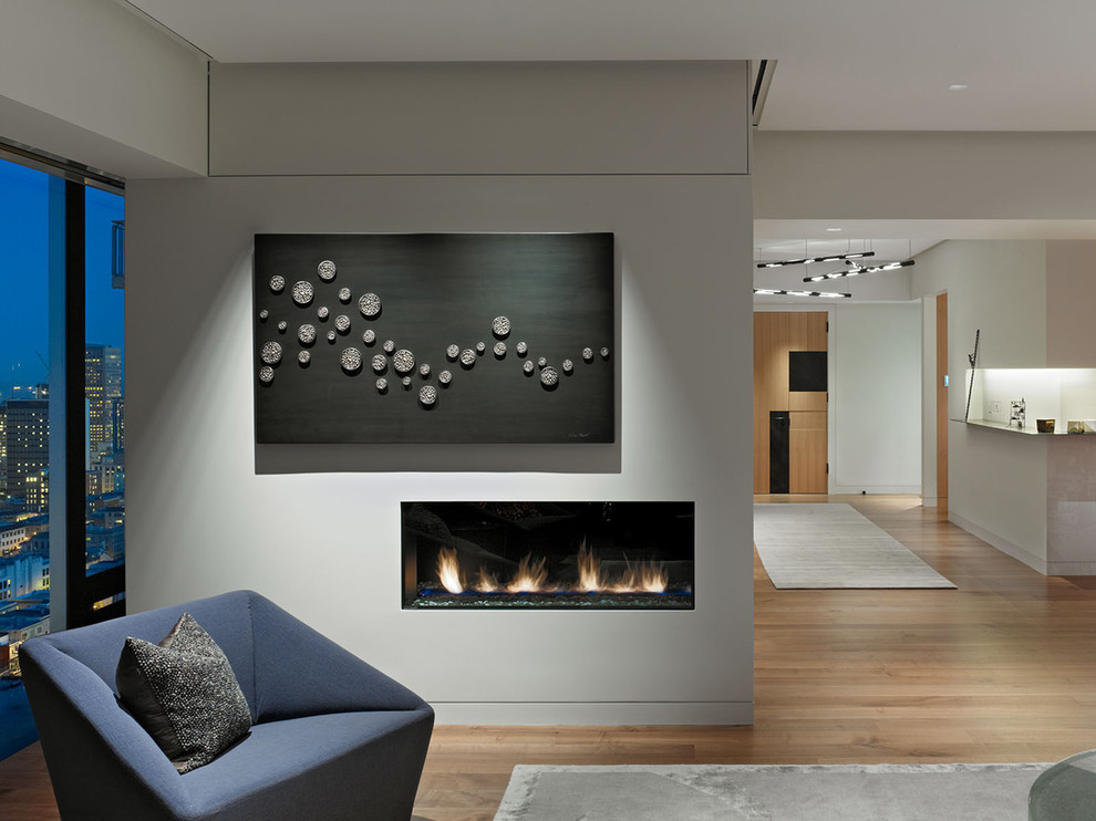 This is an example of a large modern open concept living room in San Francisco with grey walls.
