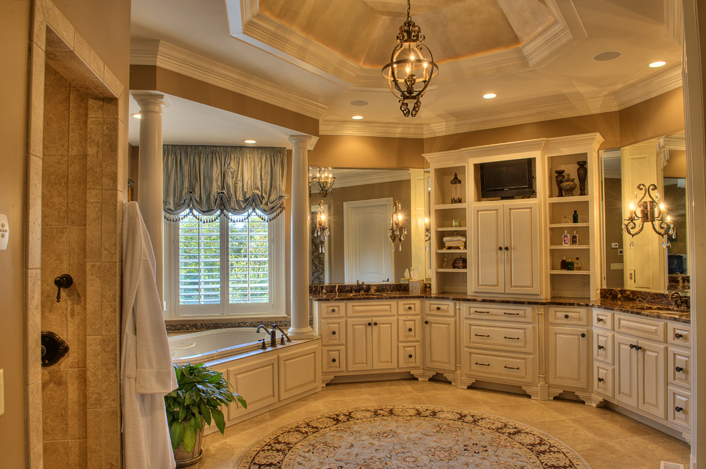 Design ideas for an expansive traditional master bathroom in Other with raised-panel cabinets, white cabinets, a drop-in tub, an alcove shower, beige walls, travertine floors, an undermount sink and marble benchtops.