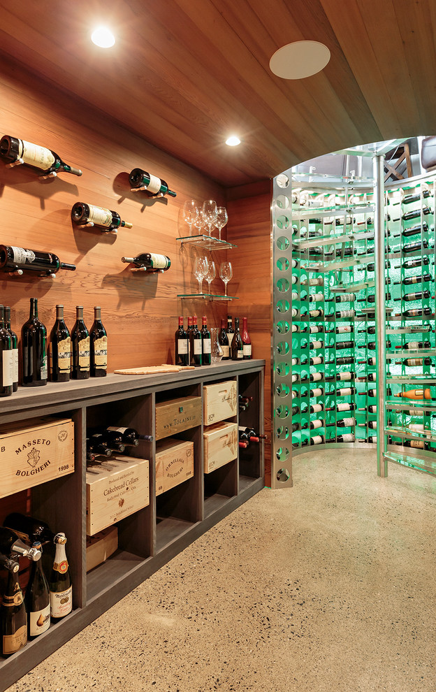 Inspiration for a mid-sized contemporary wine cellar in New York with concrete floors, display racks and grey floor.