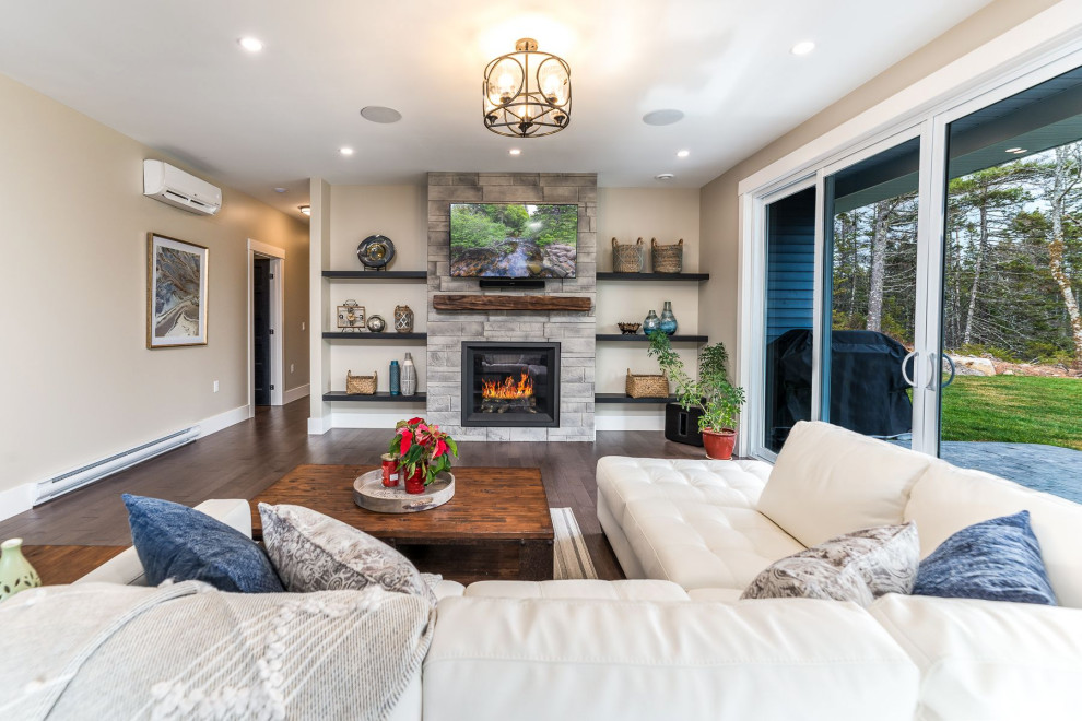 Photo of a mid-sized transitional open concept living room in Other with beige walls, medium hardwood floors, a standard fireplace, a stone fireplace surround, a wall-mounted tv and brown floor.