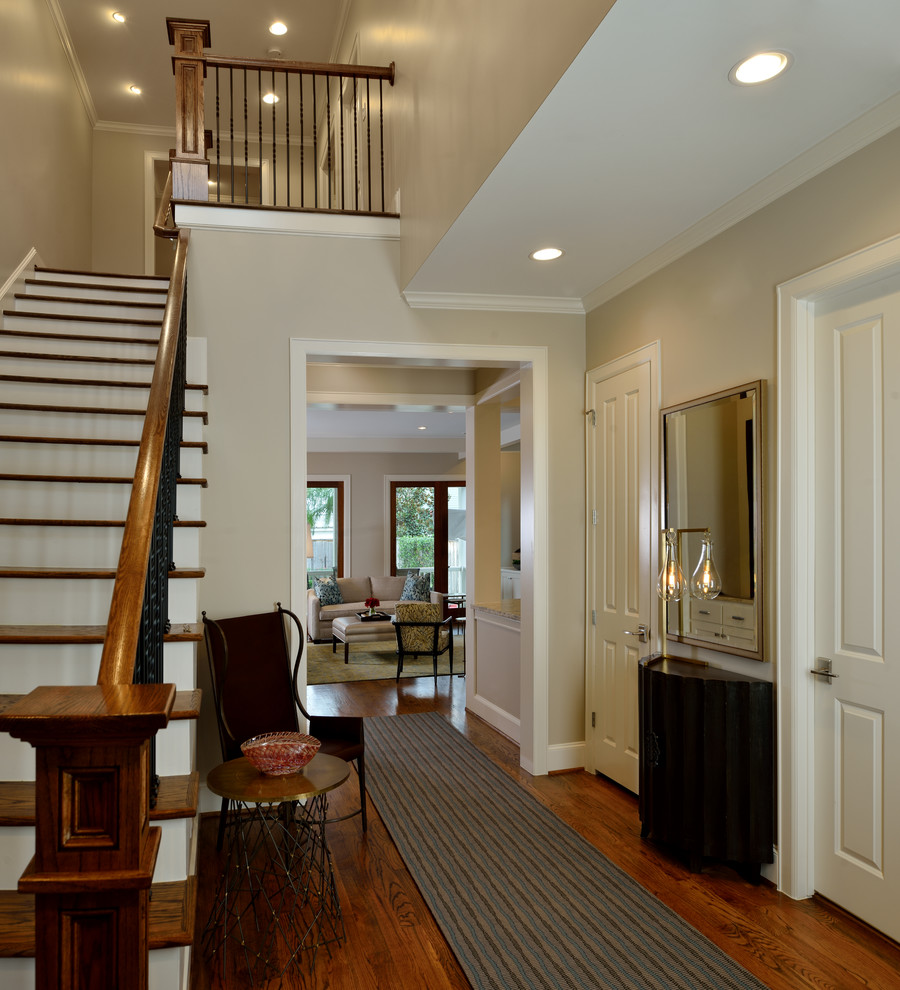 Inspiration for a mid-sized transitional medium tone wood floor foyer remodel in Houston with gray walls and a medium wood front door