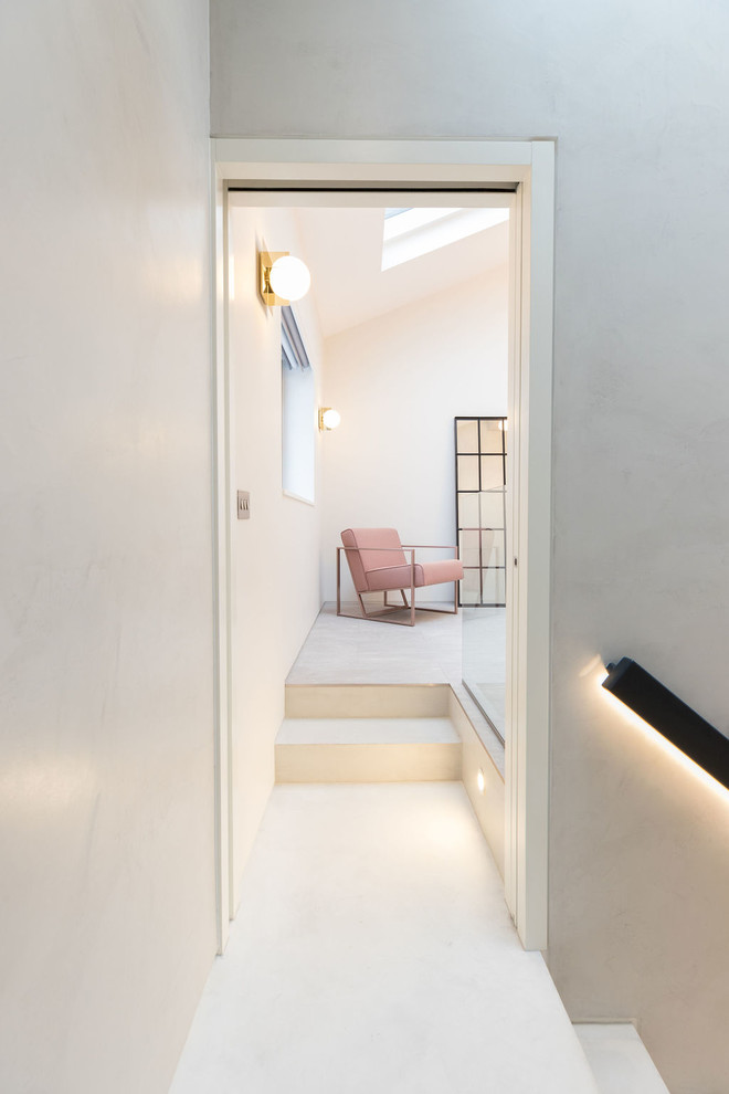 Inspiration for a small modern hallway in London with grey walls, concrete floors and grey floor.