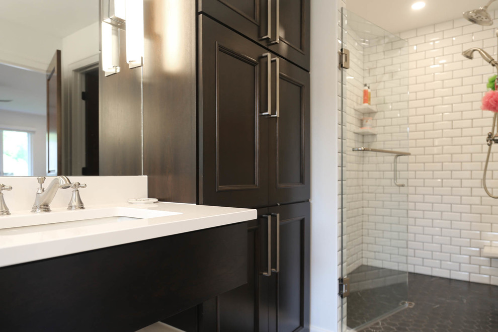 Mid-sized transitional master white tile and subway tile porcelain tile and black floor freestanding bathtub photo with flat-panel cabinets, dark wood cabinets, a two-piece toilet, white walls, an undermount sink, quartzite countertops, a hinged shower door and white countertops