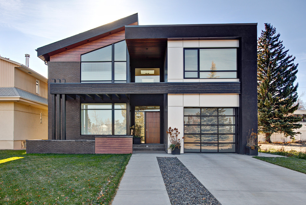 Design ideas for a contemporary two-storey multi-coloured house exterior in Calgary with mixed siding and a shed roof.