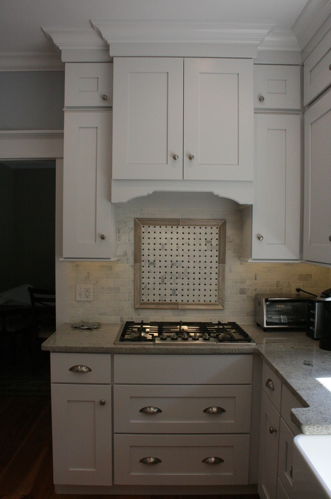 Example of a transitional kitchen design in Nashville with flat-panel cabinets, white cabinets and granite countertops