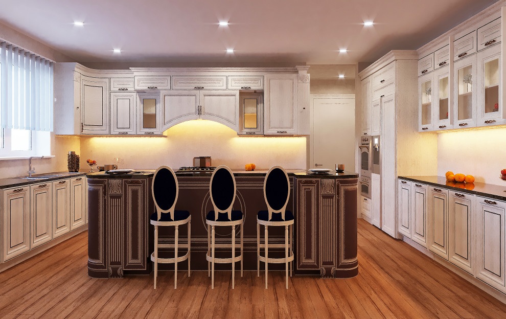 Photo of a medium sized classic u-shaped enclosed kitchen in DC Metro with a built-in sink, raised-panel cabinets, beige cabinets, marble worktops, stainless steel appliances, an island and black worktops.