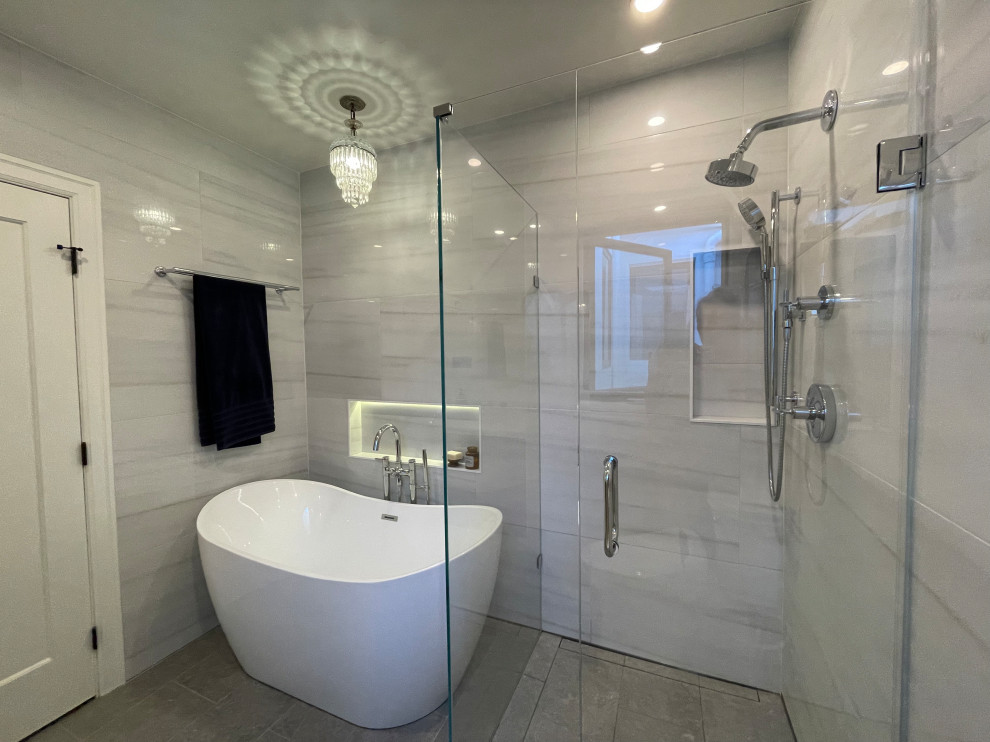 Inspiration for a medium sized traditional ensuite bathroom in San Francisco with flat-panel cabinets, dark wood cabinets, a freestanding bath, a corner shower, a bidet, white tiles, porcelain tiles, grey walls, porcelain flooring, a submerged sink, engineered stone worktops, grey floors, a hinged door, white worktops, a wall niche, a single sink and a floating vanity unit.
