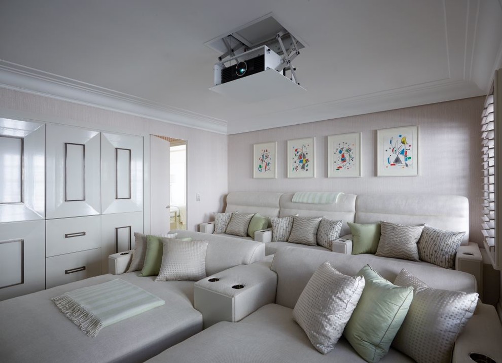 This is an example of a mid-sized transitional enclosed home theatre in London with beige walls and a projector screen.