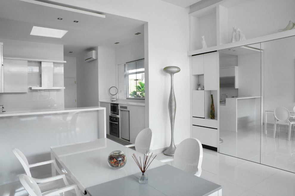 Mid-sized modern u-shaped eat-in kitchen in Singapore with an undermount sink, flat-panel cabinets, white cabinets, solid surface benchtops, white splashback, stainless steel appliances, porcelain floors and no island.