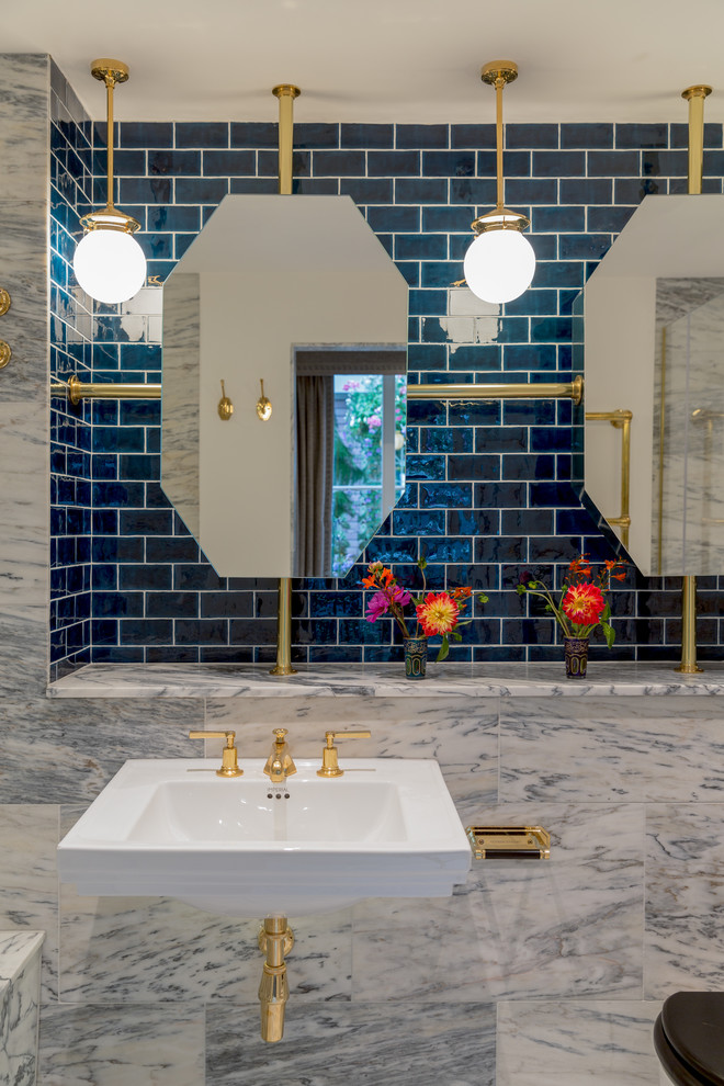 Inspiration for a large eclectic master bathroom in London with an alcove tub, an open shower, a one-piece toilet, blue tile, ceramic tile, grey walls, marble floors, a wall-mount sink, marble benchtops, grey floor, a hinged shower door and grey benchtops.
