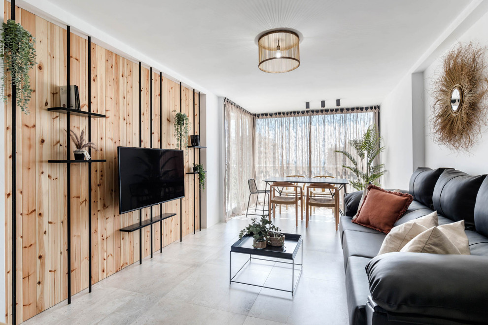 Immagine di un soggiorno minimal con pareti bianche, TV a parete, pavimento grigio e pareti in legno