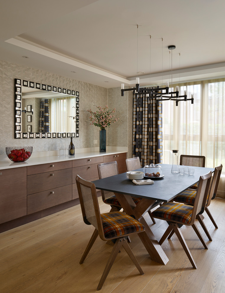 Photo of a transitional dining room in London with beige walls, light hardwood floors and brown floor.