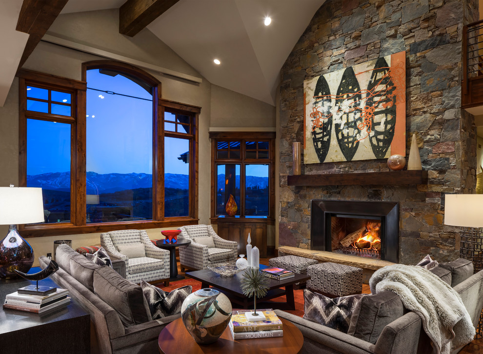 This is an example of a country living room in Salt Lake City with a standard fireplace, a stone fireplace surround and beige walls.