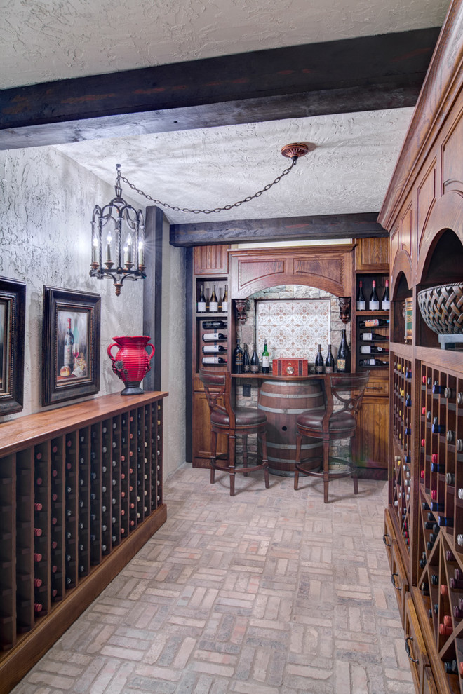 Inspiration for a mid-sized mediterranean wine cellar in Atlanta with brick floors, display racks and grey floor.