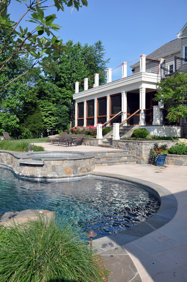 Inspiration for an expansive eclectic backyard custom-shaped natural pool in Baltimore with a hot tub and natural stone pavers.