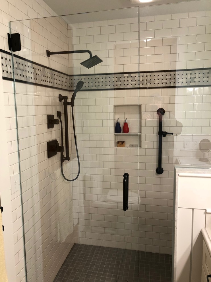 Photo of a small country bathroom in Grand Rapids with shaker cabinets, a curbless shower, a two-piece toilet, white tile, porcelain tile, an undermount sink, engineered quartz benchtops, a hinged shower door and yellow benchtops.