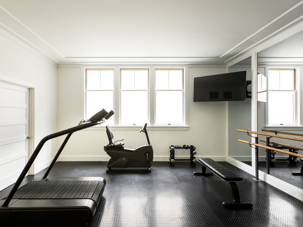 This is an example of a small traditional multi-use home gym in Los Angeles with white walls and black floors.