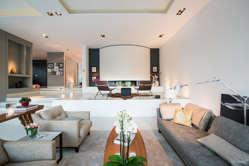 Inspiration for an expansive contemporary open concept family room in Leipzig with white walls, a ribbon fireplace and no tv.