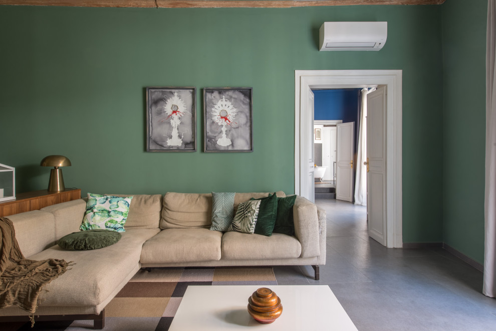 This is an example of a family room in Catania-Palermo with green walls, porcelain floors and grey floor.