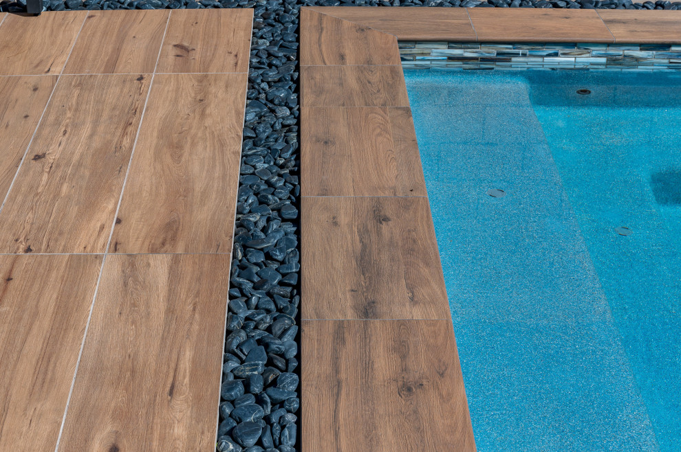 Pool - small backyard tile and rectangular pool idea in Phoenix