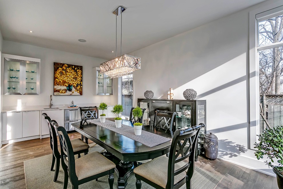 Transitional light wood floor enclosed dining room photo in Toronto with white walls and a ribbon fireplace