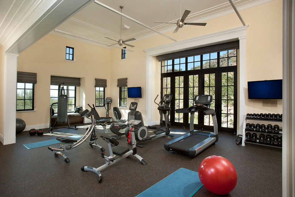 Design ideas for a large contemporary home weight room in Phoenix with beige walls and brown floor.