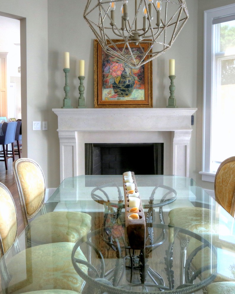 Dining room in Other with a hanging fireplace and a stone fireplace surround.