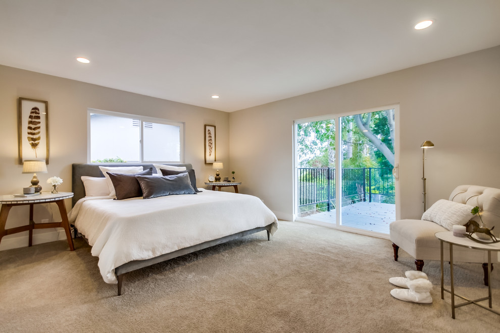 Large midcentury master bedroom in San Diego with grey walls, carpet and no fireplace.