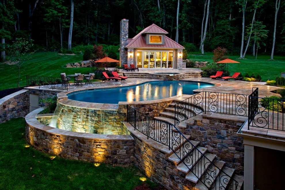 Example of a large backyard stone and custom-shaped lap hot tub design in New York