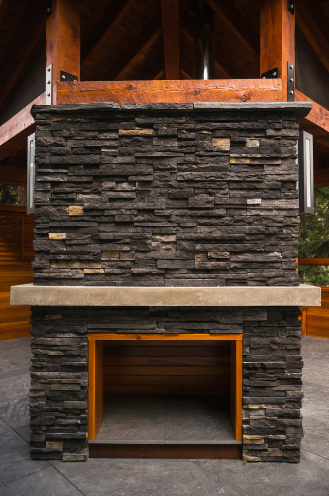 Mountain style backyard deck photo in Calgary
