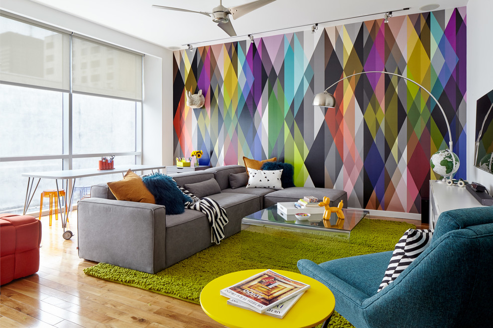 Photo of a large contemporary gender-neutral kids' room in Philadelphia with light hardwood floors, multi-coloured walls and beige floor.