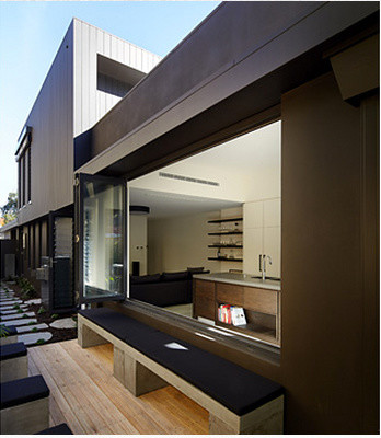 Photo of a mid-sized contemporary side yard deck in Sydney with a water feature.