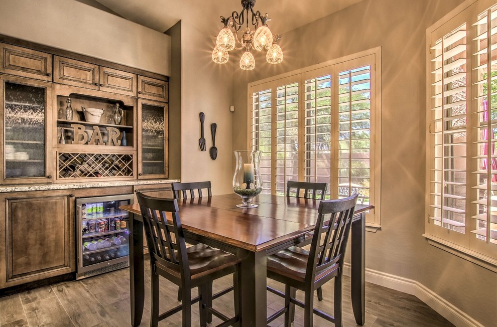 Inspiration for a mid-sized eclectic porcelain tile and brown floor eat-in kitchen remodel in Phoenix with raised-panel cabinets, granite countertops and an island