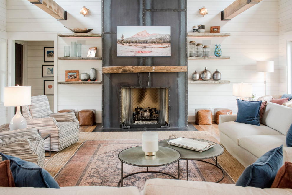 Farmhouse open concept medium tone wood floor, brown floor and shiplap wall living room photo in Huntington with white walls and a standard fireplace