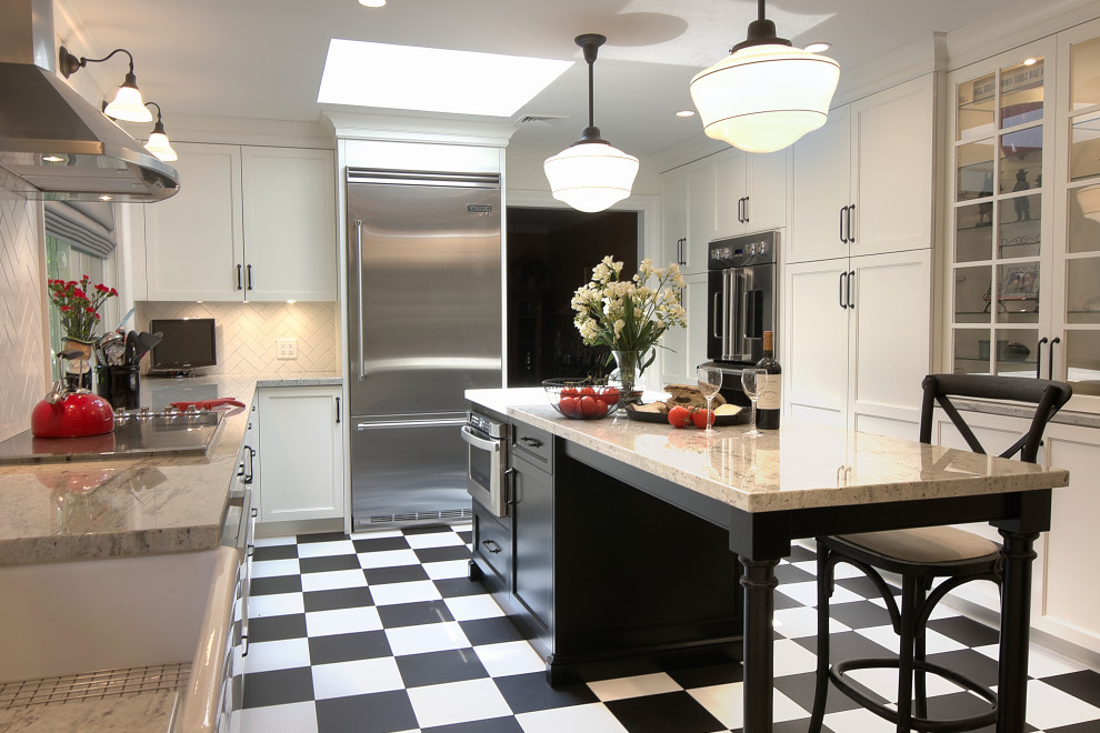 Inspiration for a transitional u-shaped multicolored floor enclosed kitchen remodel with a farmhouse sink, glass-front cabinets, white cabinets, granite countertops, white backsplash, subway tile backsplash, stainless steel appliances, an island and beige countertops