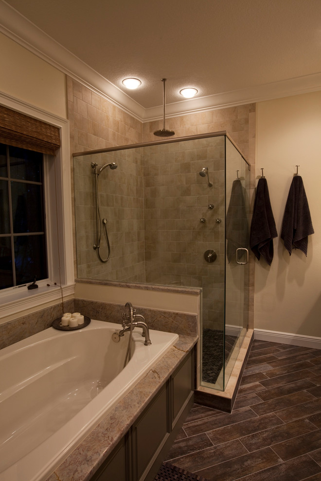 Photo of a beach style bathroom in Tampa with granite benchtops, a drop-in tub, a corner shower and wood-look tile.