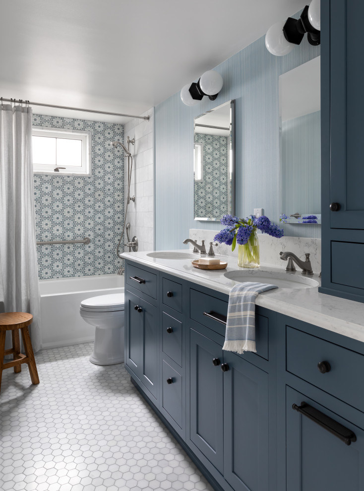 Alcove bathtub - mid-sized traditional blue tile and marble tile marble floor, double-sink and wallpaper alcove bathtub idea in Seattle with beaded inset cabinets, blue cabinets, a one-piece toilet, an undermount sink, quartz countertops, white countertops and a built-in vanity