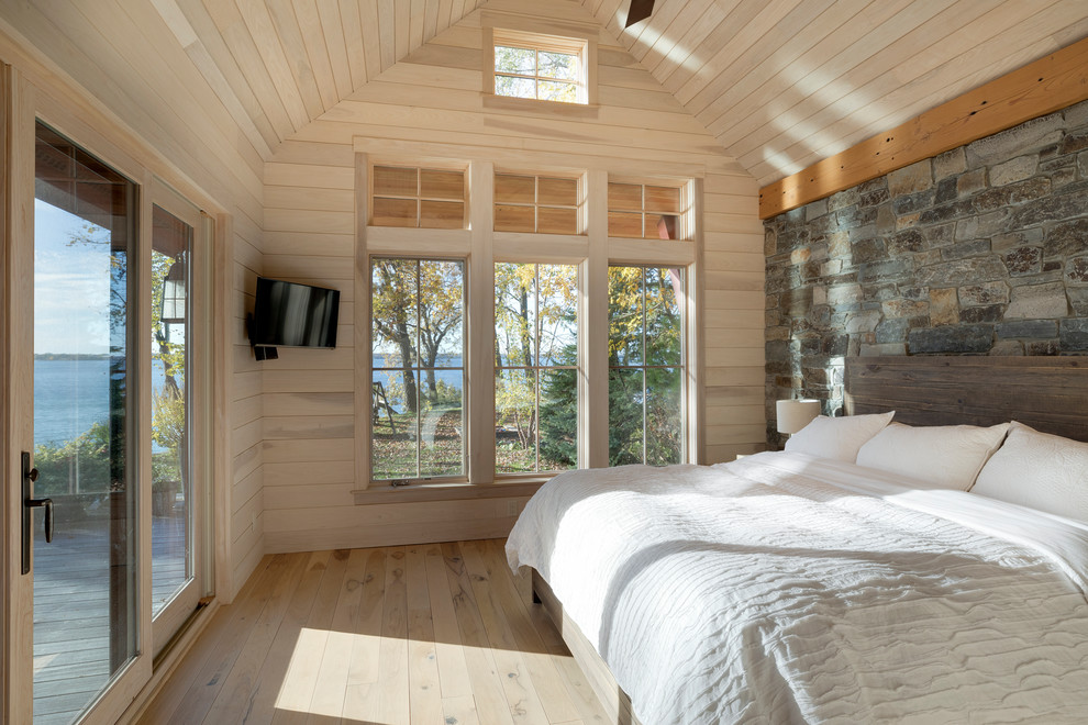 Inspiration for a country master bedroom in Minneapolis with light hardwood floors.