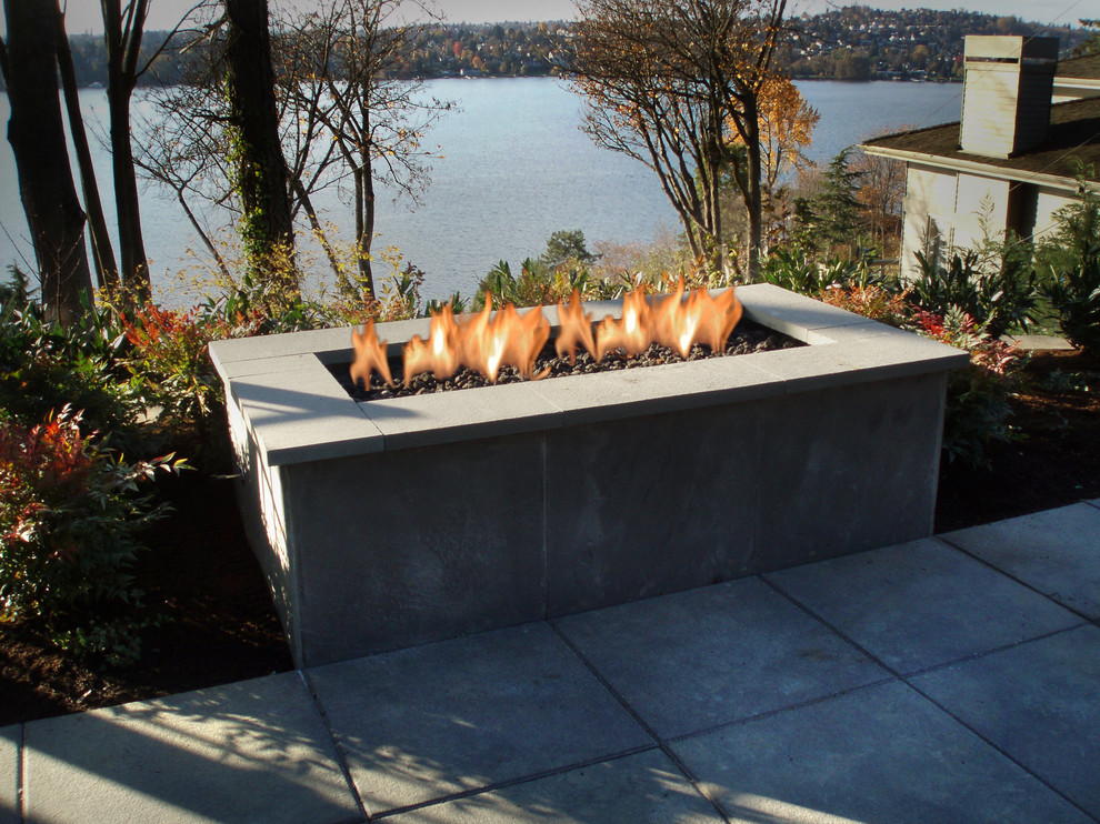 Design ideas for a mid-sized contemporary backyard shaded garden in Seattle with a fire feature and concrete pavers.