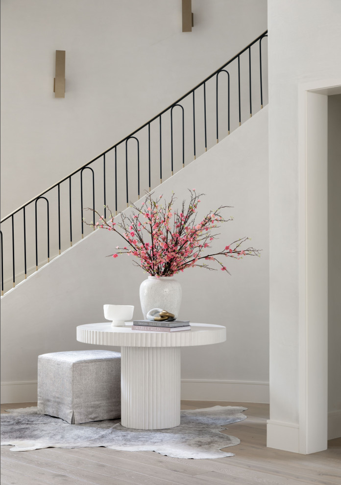 Foyer - huge transitional medium tone wood floor and brown floor foyer idea in Houston with white walls