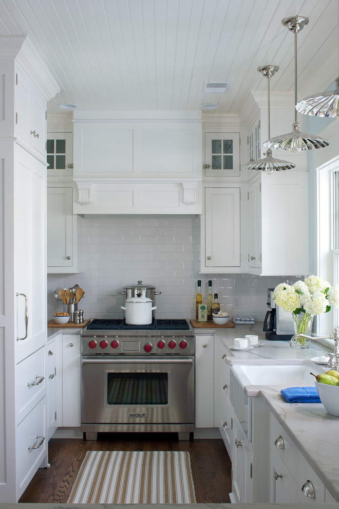 Photo of a small country u-shaped separate kitchen in Other with white cabinets, quartzite benchtops, white splashback, subway tile splashback, stainless steel appliances and a farmhouse sink.